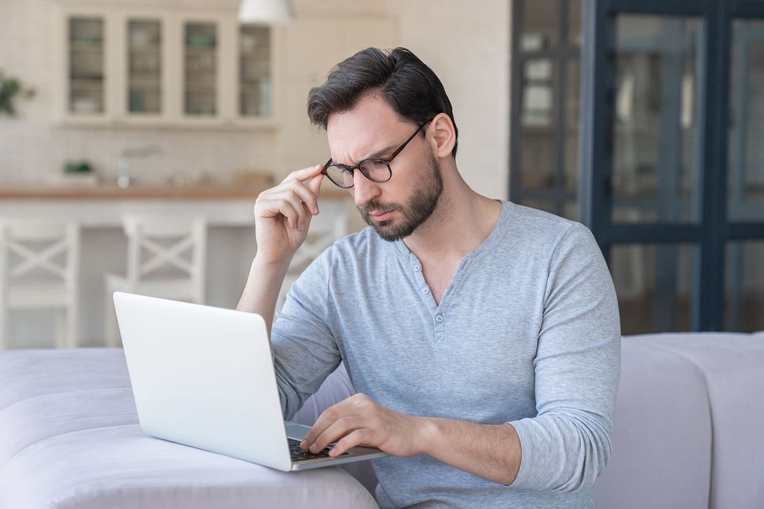 Identity crime - Man looking concerned at his laptop