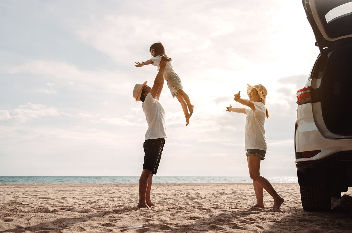 Family at the beach with their car
