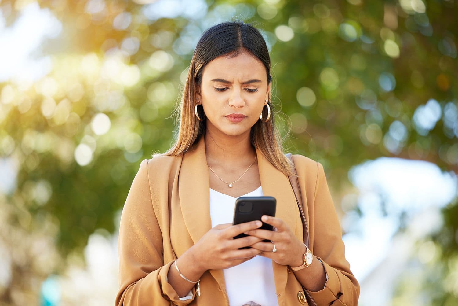 Phishing scam - women concerned expression looking at her phone