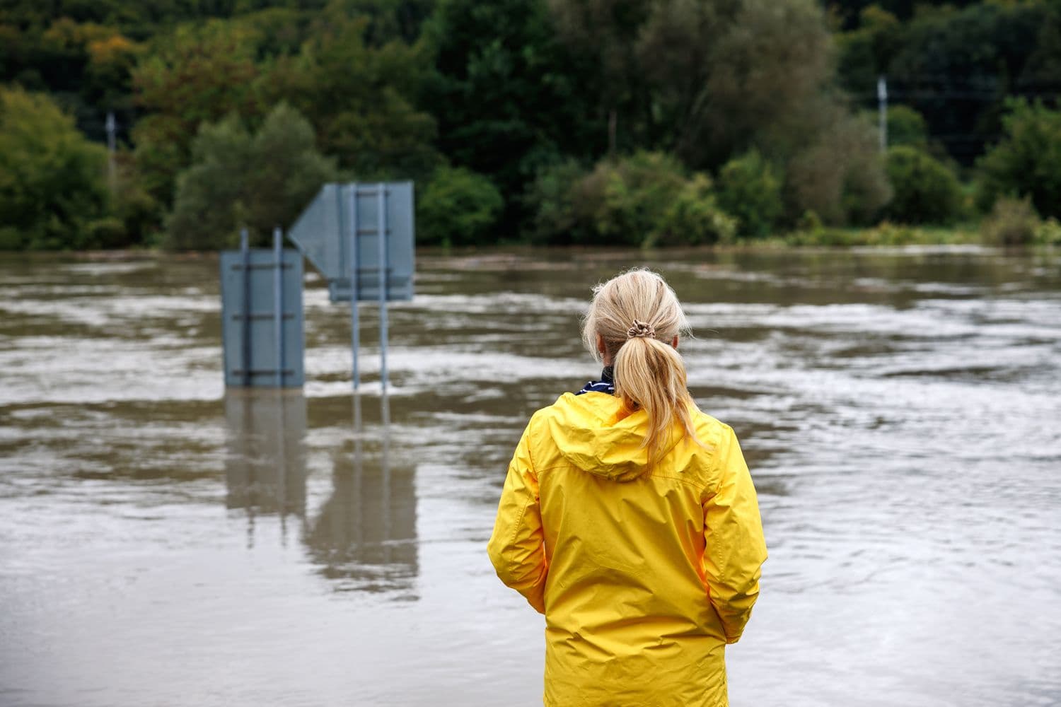 Woman standing watching the floods