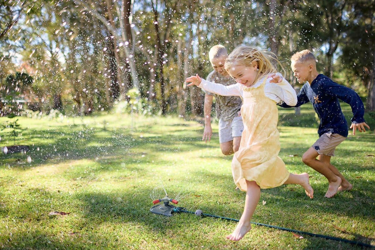 Cubs Account - Kids running through a sprinkler