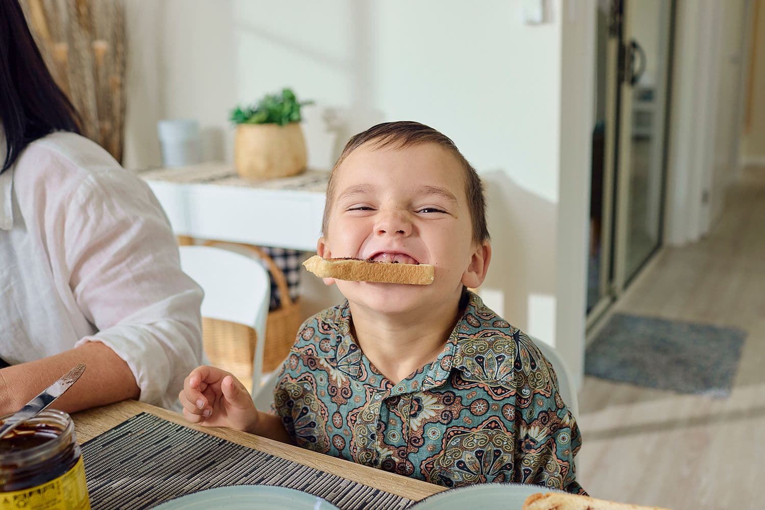 Small boy eating vegemite toast