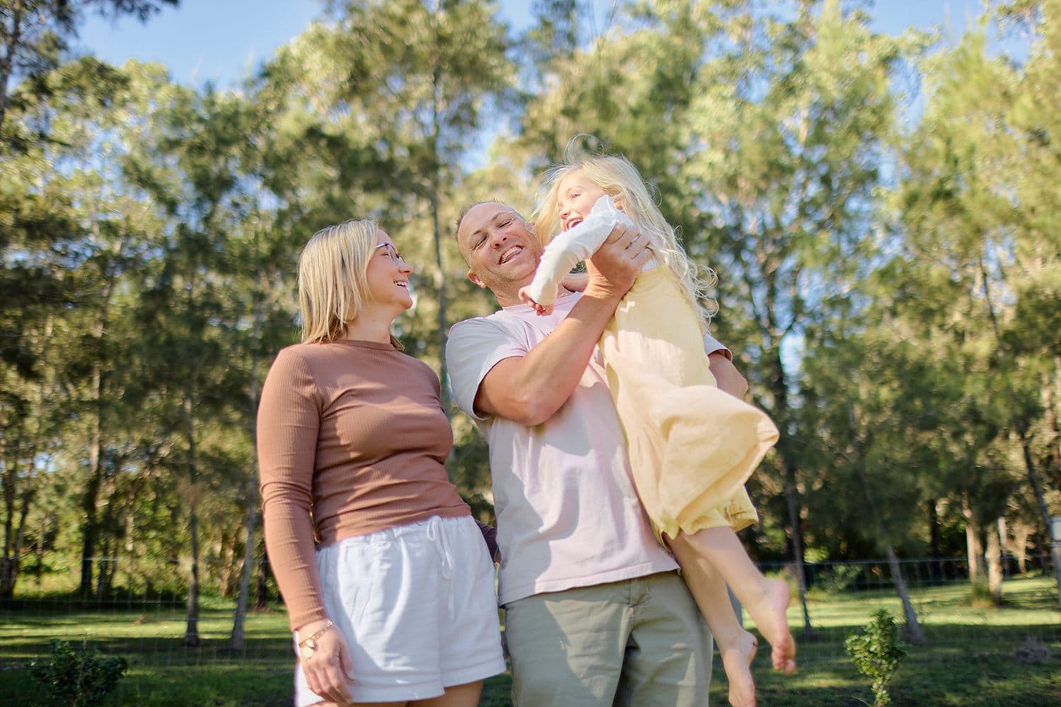 Dad lifting daughter up