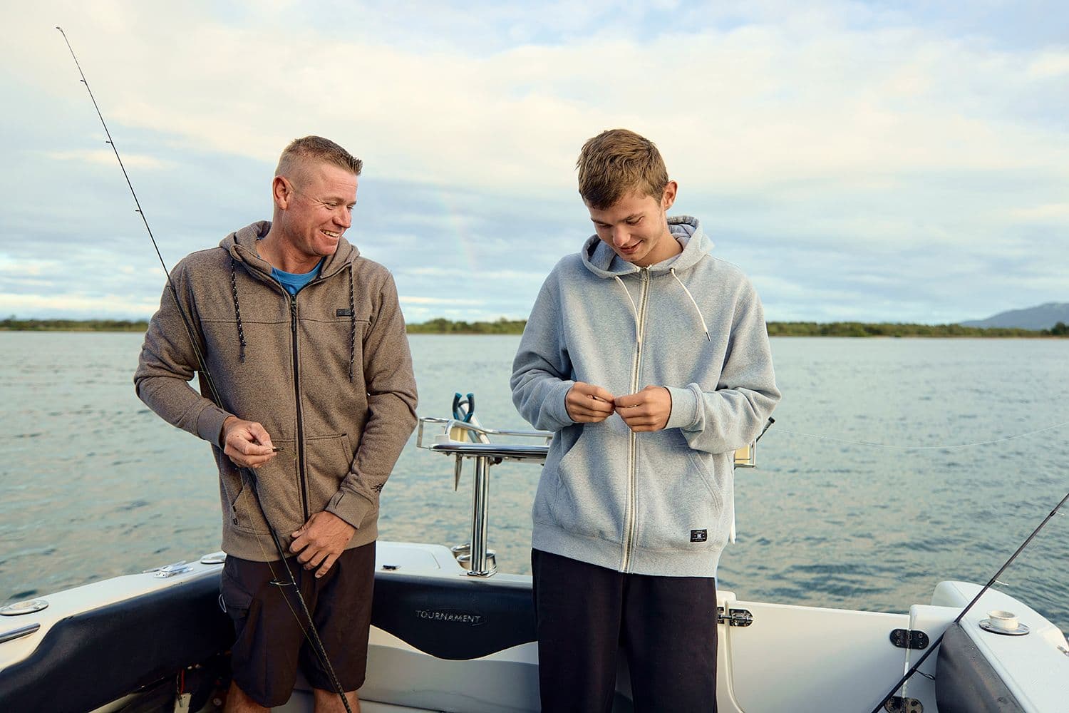 Everyday Accounts - Man on a boat fishing with his son.